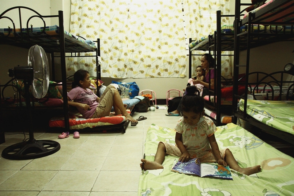 Jen (not her real name), diagnosed with lymphoma, reads a storybook inside one of the dormitory rooms while waiting for her doctor's appointment. Four to five families share living quarters, making it quite cramped and uncomfortable. It does however establish a community feel, especially among the parents who are constantly chattering and sharing experiences as if in a PTA meeting.