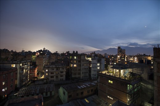 To Grow is to Grow. 
Perched high above street level, the growing number of ‘city farms’ can be seen from rooftop to rooftop. This is the latest push in sustainable food harvesting in the Kathmandu Valley. Small setup’s can provide both fruit and vegetables for families living in high-rise styled buildings, and it’s reported that families are saving up to 9,000Rs on grocery bills a month. As day slowly gives away to the night, the city here is beautifully juxtaposed by the Godawari hills in the background, standing tall as a constant reminder that nature still continues to thrive functionally in it’s pristine, untouched state. 