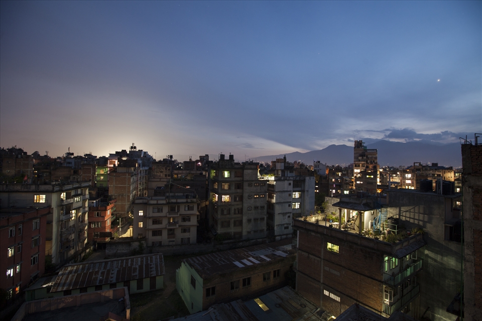 To Grow is to Grow. 
Perched high above street level, the growing number of ‘city farms’ can be seen from rooftop to rooftop. This is the latest push in sustainable food harvesting in the Kathmandu Valley. Small setup’s can provide both fruit and vegetables for families living in high-rise styled buildings, and it’s reported that families are saving up to 9,000Rs on grocery bills a month. As day slowly gives away to the night, the city here is beautifully juxtaposed by the Godawari hills in the background, standing tall as a constant reminder that nature still continues to thrive functionally in it’s pristine, untouched state. 