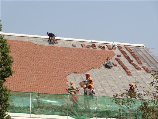 Occ Health and Safety missing here with roof retilers at work