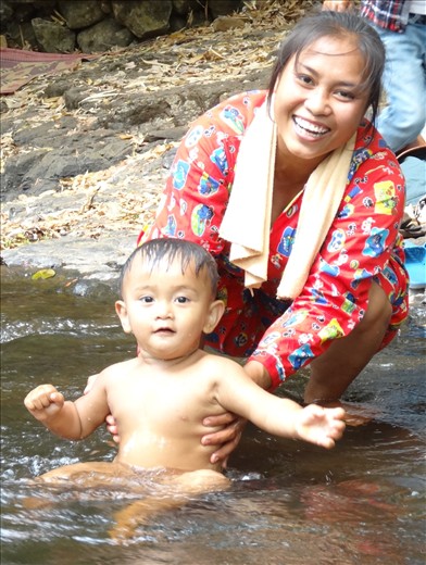 Young lad and his mum having fun in the pond