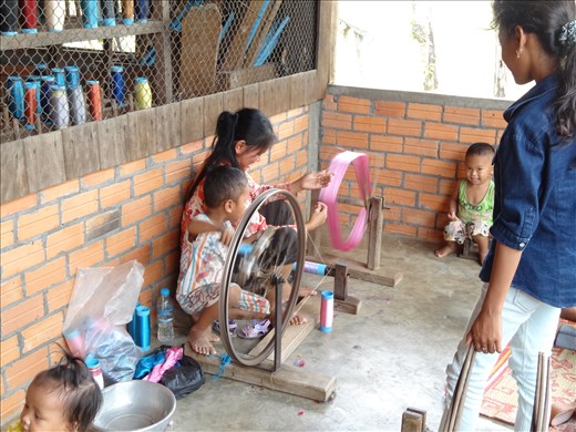 Putting the dyed silk onto cones ready for spinning