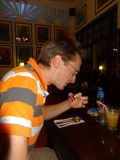 John eating his and not really enjoying it