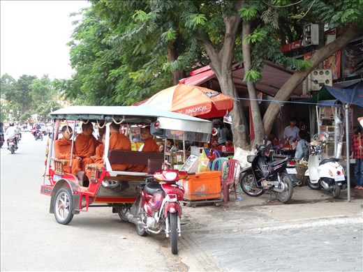 Monks sheltering from the rain near my hotel street