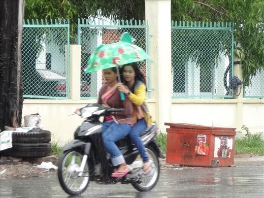 Style A riding in the rain with umbrella