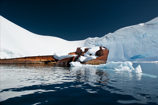 The retreating summer snow reveals unexpected details in a shallow cove off Wilhelmina Bay. Over time the decaying remains of human presence become inseparable from the landscape. 