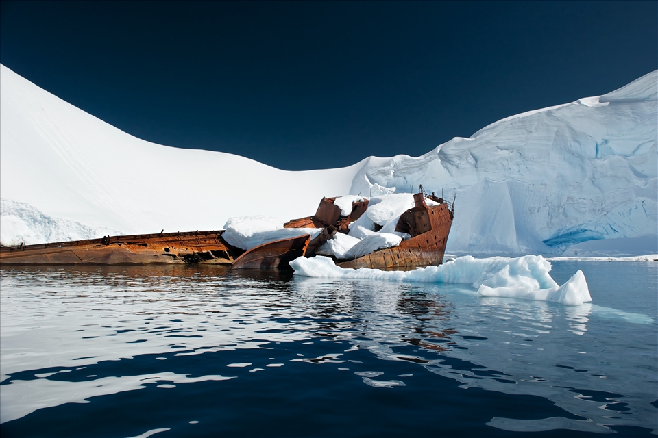 The retreating summer snow reveals unexpected details in a shallow cove off Wilhelmina Bay. Over time the decaying remains of human presence become inseparable from the landscape. 