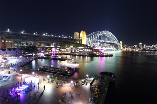 A lone figure casts a long shadow as they take in the awe of the city.