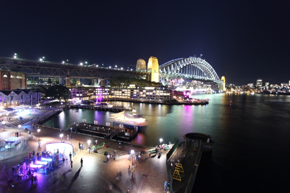 A lone figure casts a long shadow as they take in the awe of the city.