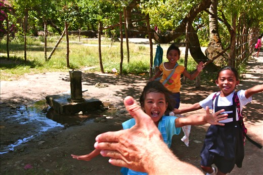 Hi-Five! Greeting the children after school from a motorbike.