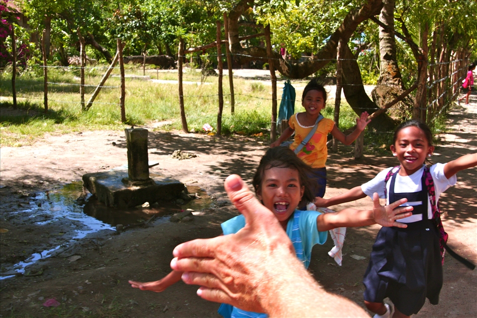 Hi-Five! Greeting the children after school from a motorbike.