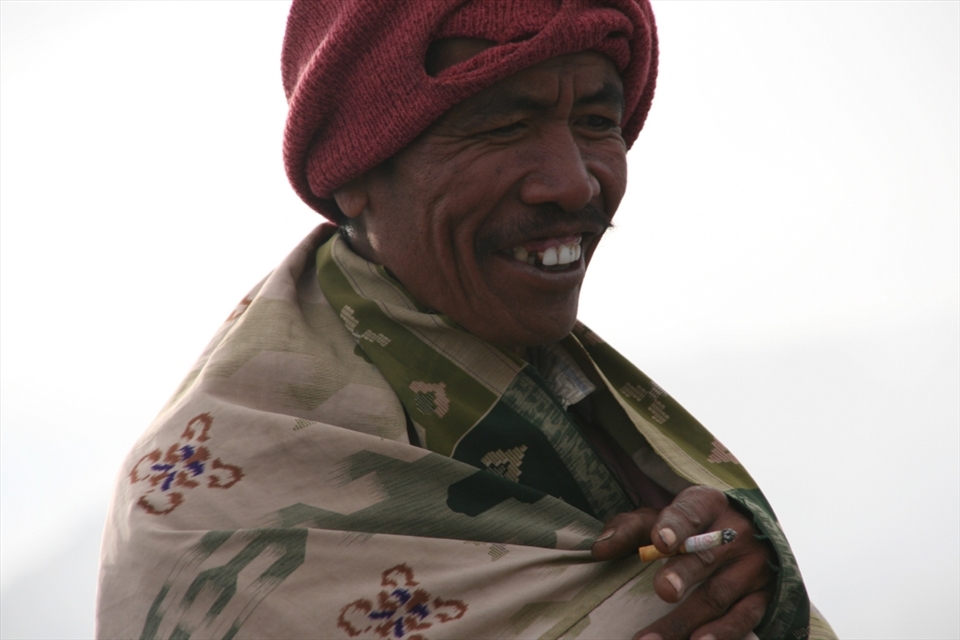 At the top of Mt Bromo, a Tenggerese is wrapped up against the cold. He is one of the workers who collect sulphur from the inside the caldera. 