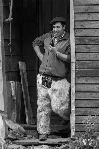 A gaucho, is a typical guy from the Patagonia This man is wearing gaiters made with goat leather and is talking by vhf radio, which is the only way to comunicate with other people when they live in the middle of the Andes