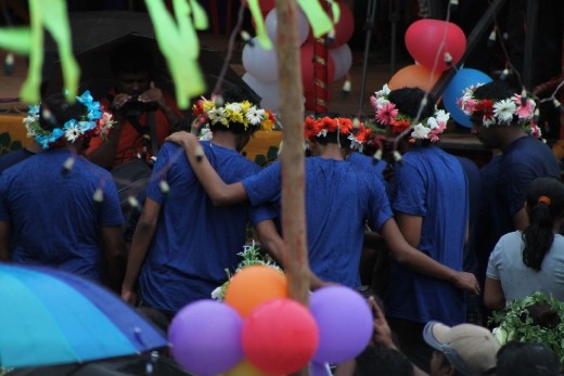 Group having great time with colorful wreath and costumes