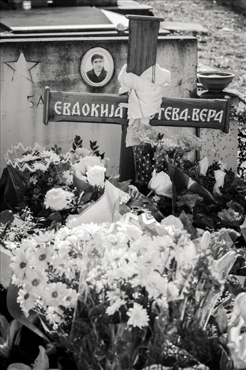 A simple wooden cross marks the grave of Vera Foteva. It is immediately covered in bunches of flowers, representing the respect and admiration people have for her.
