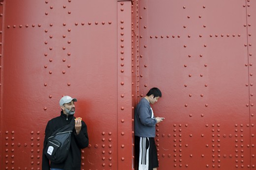 Two men at the Golden Gate Bridge in San Francisco portray the currently widespread sense of lack of human interaction, a feeling that many people have in western culture in a time called, paradoxically, the age of communication and social networks.

