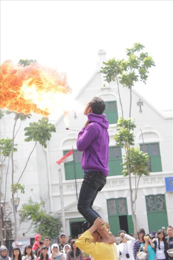The man shows afraid gesture while the fire blazes beautifully and calm.