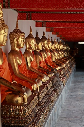walking  slowly around the Bangkok  wat pho temple you see such expert craftmanship applied to virtually every corner of the grounds as you see here on  a rear wall joining two buddha temples.I call it the temple of a 100 buddhas.If you look closely you'll see every buddhas face is unique and individual.