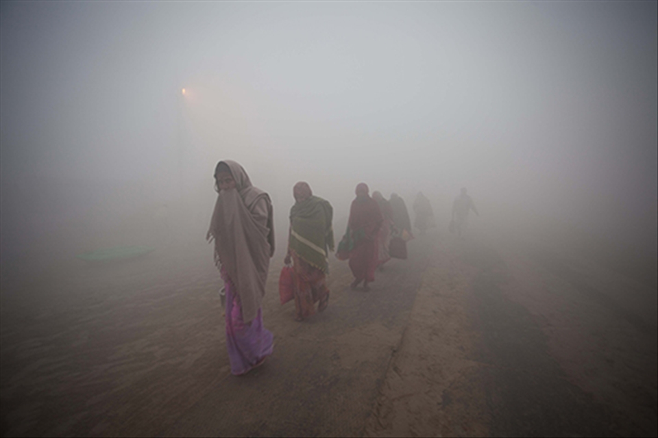 female devotees going to take holy dip on cold foggy mornings at kumbh mela
