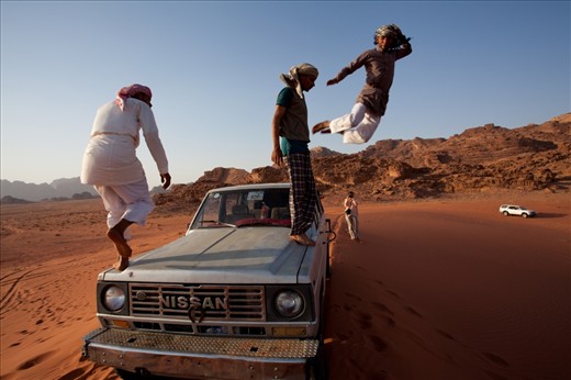 While we were enjoying the spectacular desert sunset, the cheerful and playful Bedouin tour guides drive the jeep up to the top of the Sandune, and jump from the top in a 
