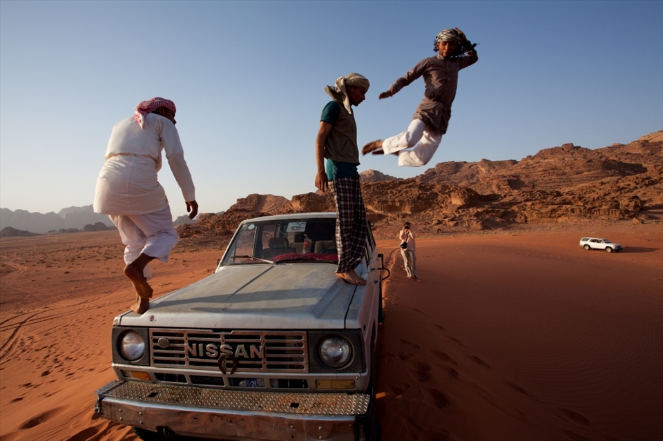 While we were enjoying the spectacular desert sunset, the cheerful and playful Bedouin tour guides drive the jeep up to the top of the Sandune, and jump from the top in a 