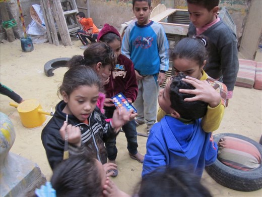 Children from El-Khalifa were given a rare chance to play in an open space. At this moment they have gathered to paint Egyptian flags on each other's cheeks.