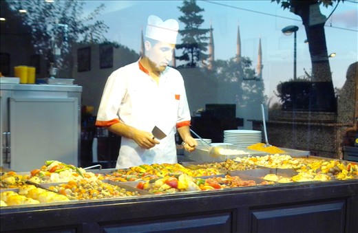 SWEETS DELIGHT. A merchant is captured on camera attending to his stall. 