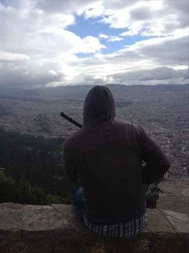 Sebastian and his quena, a small Andean flute, taking in the view 