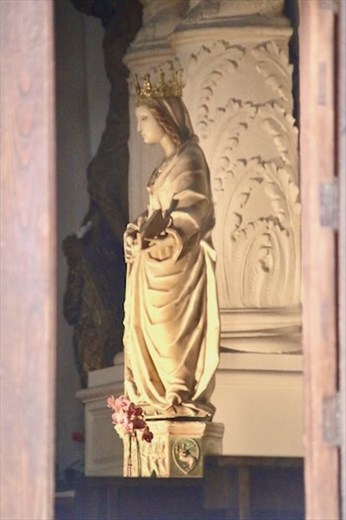 Mary, through an open church door in Taormina