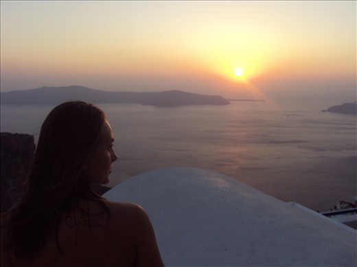 My tattooed friend is fascinated by the sunset scene in Santorini island,Greece.