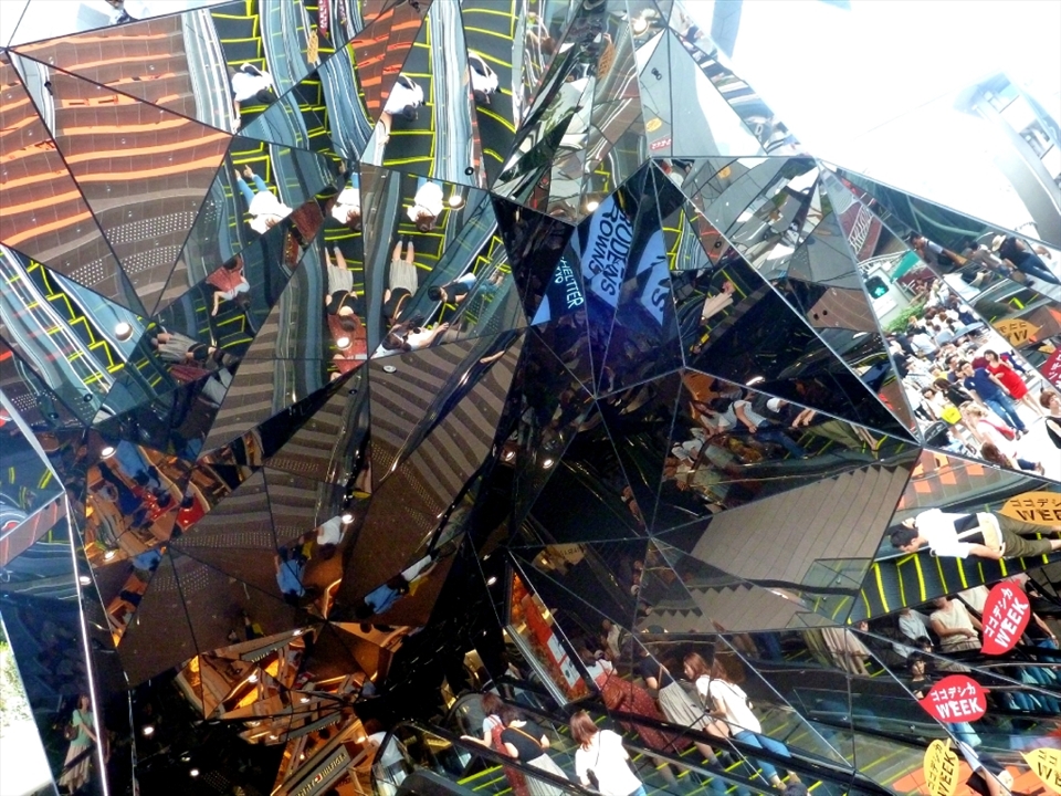 This is the entrance to a large shopping centre on one of Tokyo's major shopping streets. 
I feel it captures the bustling consumerism of the city