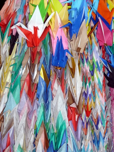 Origami birds are left as an offering at one of the numerous temples in Kyoto. 
This depicts the strong sense of faith and the importance of religion in modern day Japan