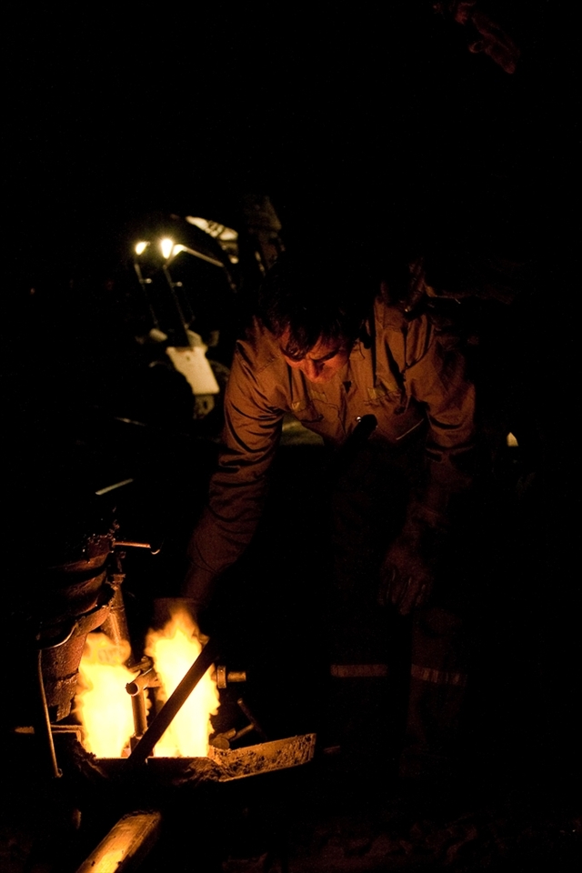 With 30 plus degrees, this railroad worker prepares to melt the iron to repair the rail before sunset, less then 3 hours before the next train is scheduled.