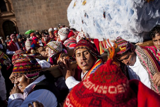 Sharing the weight of the giant Saints, proudly wearing traditional dress.