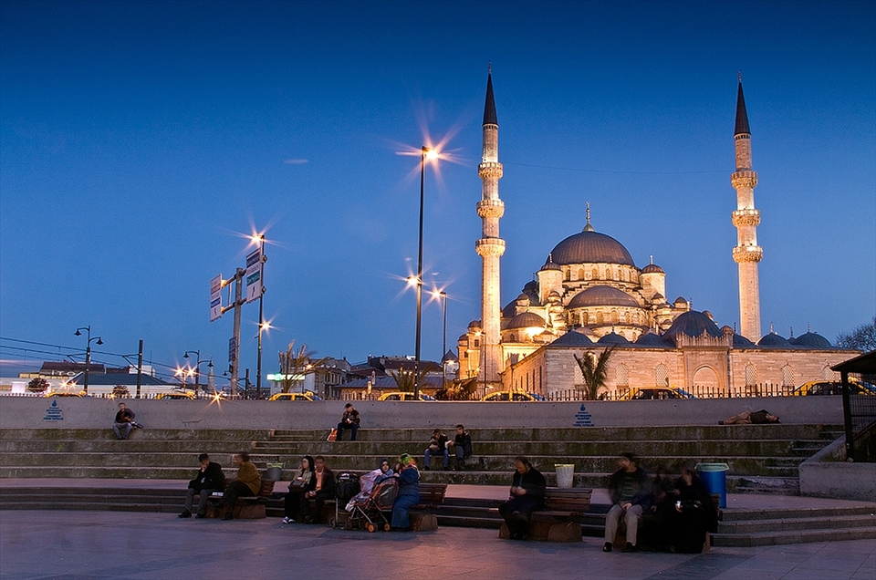 Classic Turkish architecture with the dome and minarets of the mosque imposing on the Istanbul night  .