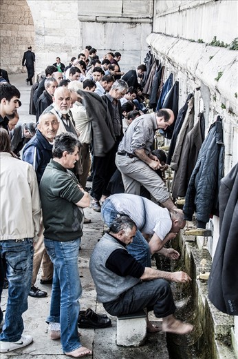 Turkish men washing their feet before entering the mosque in Istanbul