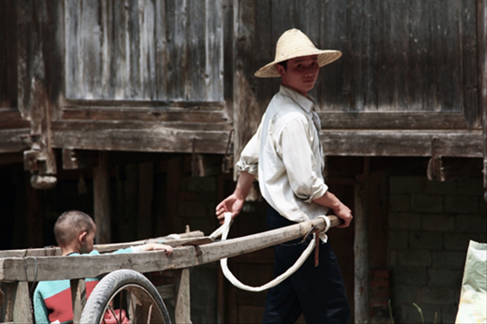 A father carries his child on a hay cart in Dimen, a Dong-minority village in China's Guizhou Province. 

Time seems to have stopped 100 years ago in this little hidden place. Only a few researchers are invited to live among this remote community every year.