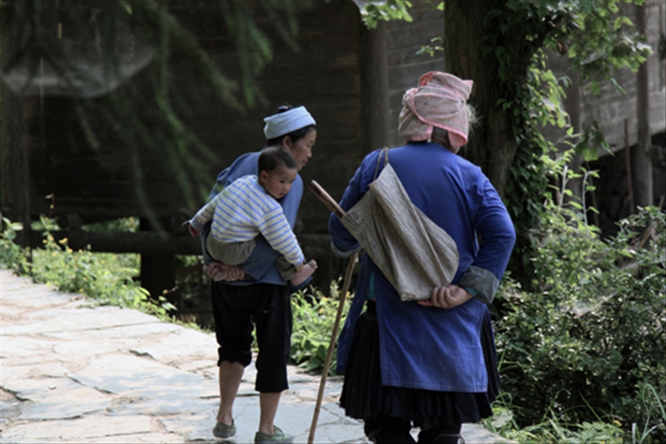 Three generations in Dimen, a Dong-minority village in China's Guizhou Province.

Since the young generation often has to leave their homes for jobs in the city, it's the grandparents who bring up the children.

The Dong people teach children about life by making up songs - something that is also used when trying to impress a love interest.