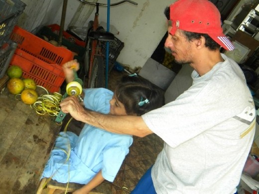 Jorge and a neighbouring school girl who always came over after classes were peeling oranges in preparation for pressing. Later the juice was bottled and sold around town by a friend with a basket and ice-cooler on front of his bike.