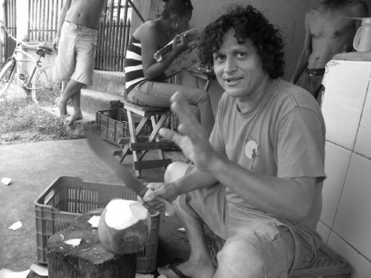 Willy, my home-stay 'brother', a local coconut vender. He collected coconuts from the nearby forest and chilled them in a fridge. He then cut the husk off them and prepared them for drinking. His friends would then come by bike and collect the coconuts to sell around town and make a small profit. As you can see from this photo his garage was the local 'hang-out' spot of the neighborhood. All day people would come and go, without a care in the world!