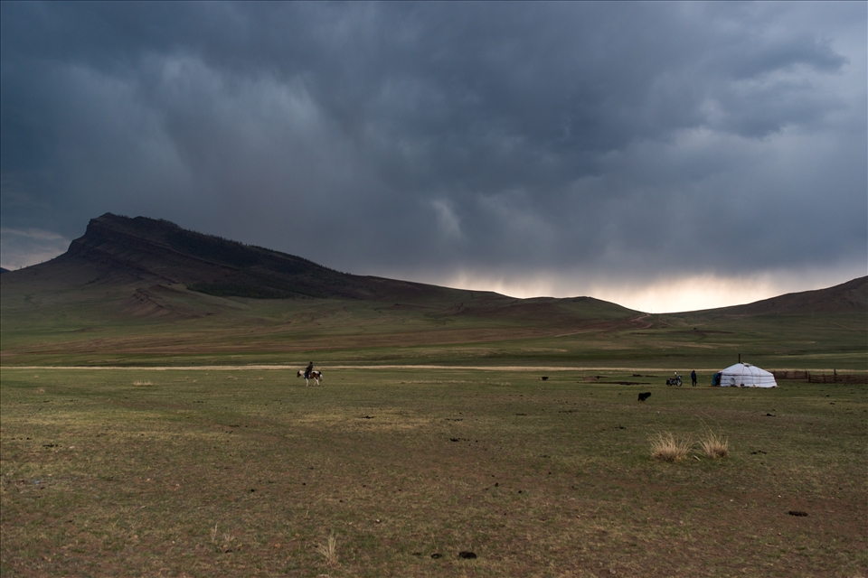 Before the storm. Typical Mongolian scene: horseman, tent and motocycle