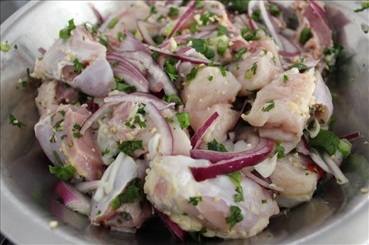 Chicken chopped into pieces with garlic, onion, pepper, scallions and parsley.