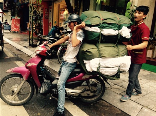 You can transport just about anything on a scooter. Here goes a load of hotel laundry.