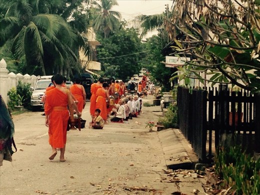 The monks slowly walk by around 5.30 in the morning and collect their alms for the day.