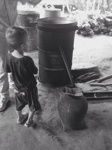 Local method of whiskey brewing: rice is cooked, then fermented with herbs in a pot for two weeks, then boiled over a wood fire where the condense is captured and bottled.