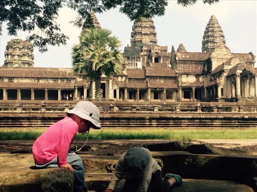 This is how toddlers explore the world's largest religious monument - by jumping on rocks and looking for bugs.