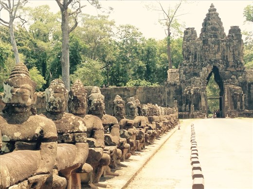 Buddhas lined up at the gate of Angkor Thom, a thick wall and moat surrounding the former royal palace and the Bayun temple.