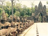 Buddhas lined up at the gate of Angkor Thom, a thick wall and moat surrounding the former royal palace and the Bayun temple.: by hannap, Views[264]