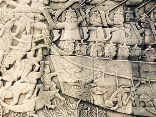 Detail on the wall of the Bayun temple, representing a battle between the Cambodians and the ancient Vietnamese on Tonle Sap lake, a soldier who felt out of the boat got bitten by crocodiles (this made a lot of impression on the kids).