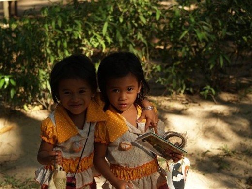 Two sisters were selling postcards to visitors.